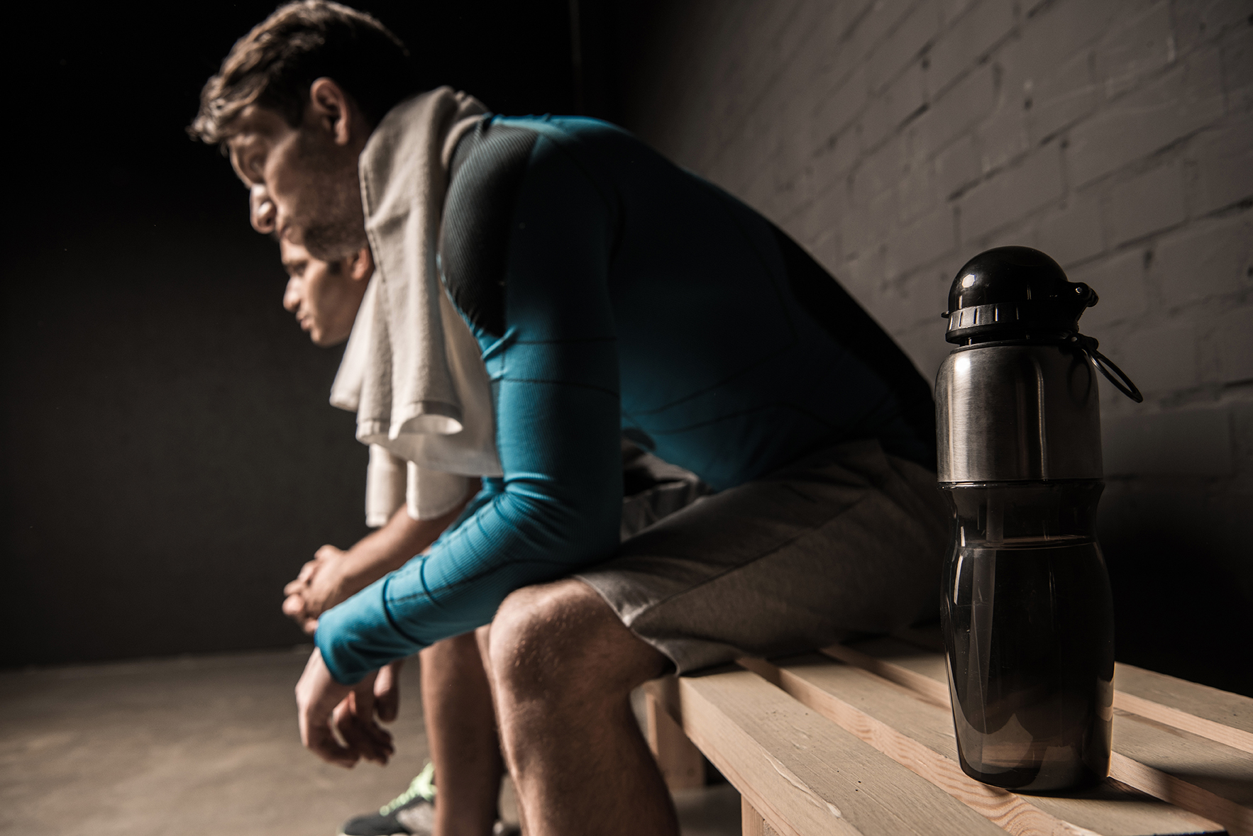 male athletes resting at gym locker room - Legends Custom Lockers secure locker rooms