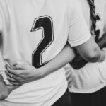 Close up of female football players huddling