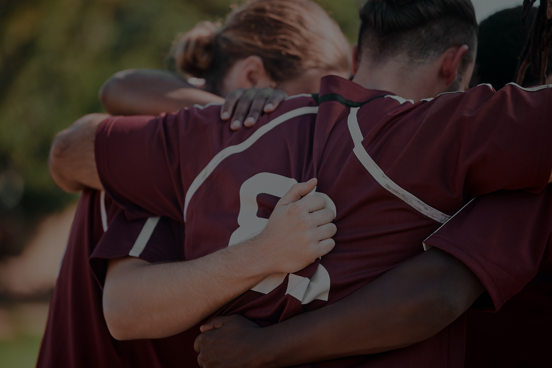 Football team, hug and fitness with sports on field, prayer and motivation with support. Men, diversity and athlete group with collaboration for game, back and solidarity with commitment in circle.